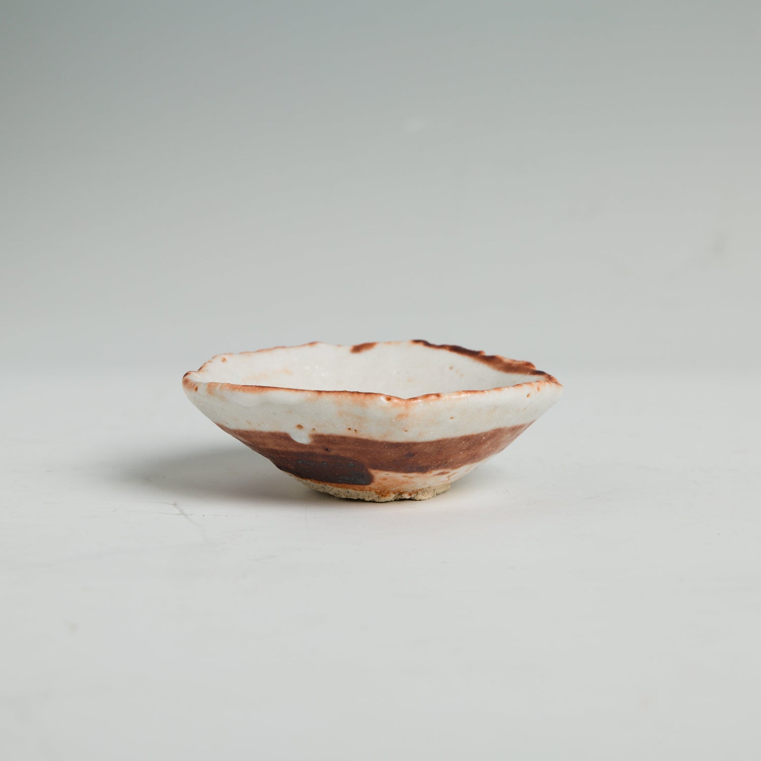 Low wide Shino sake cup side view by Hideki Yanashita