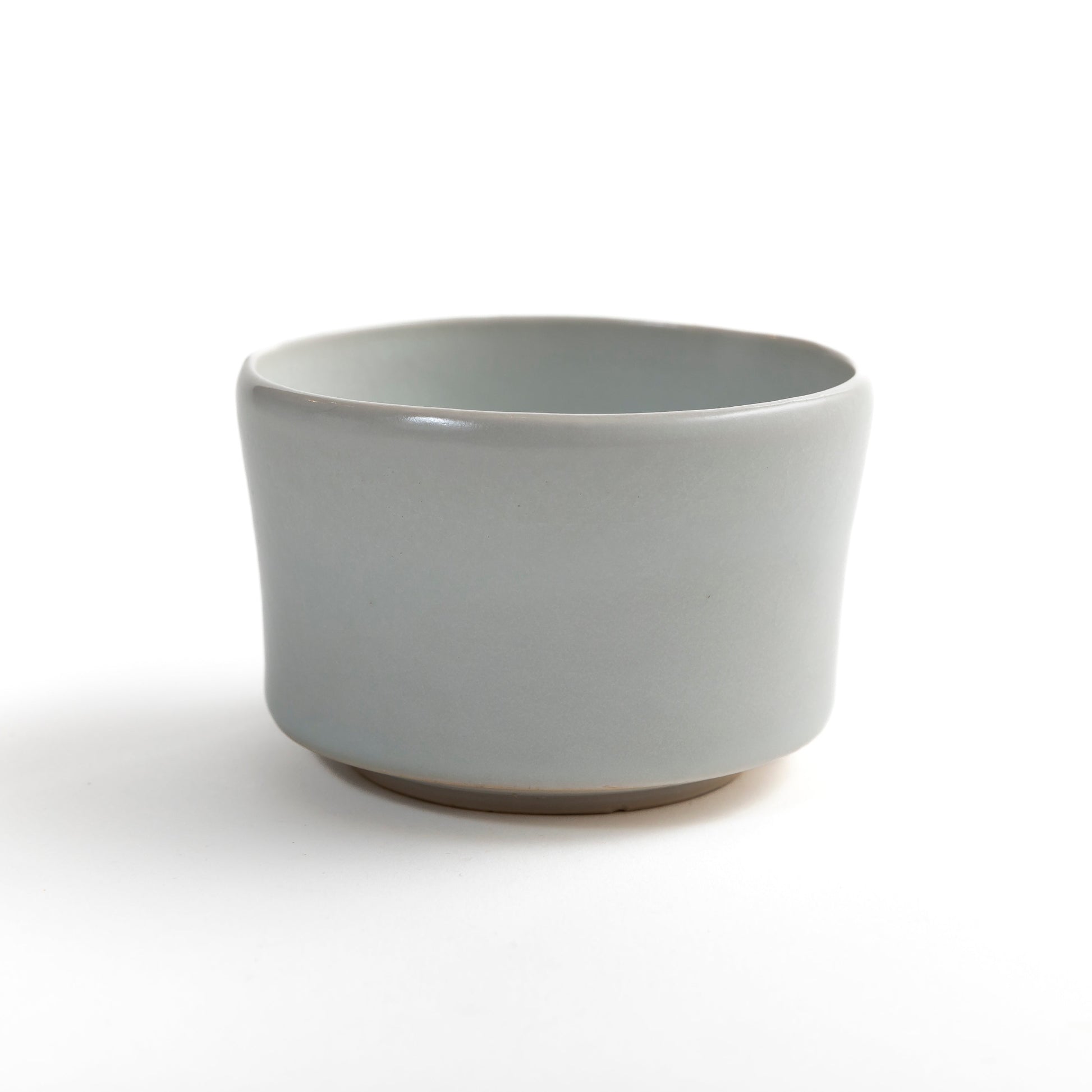 Side view of ivory white travel tea bowl