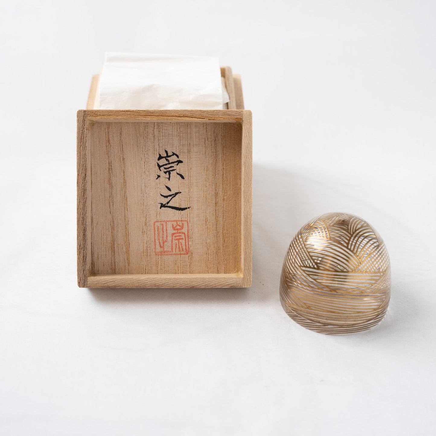 The acrylic wave small box standing next to its traditional paulownia wooden box (Tomobako), featuring the handwritten calligraphy and red seal stamp of artist Takayuki.