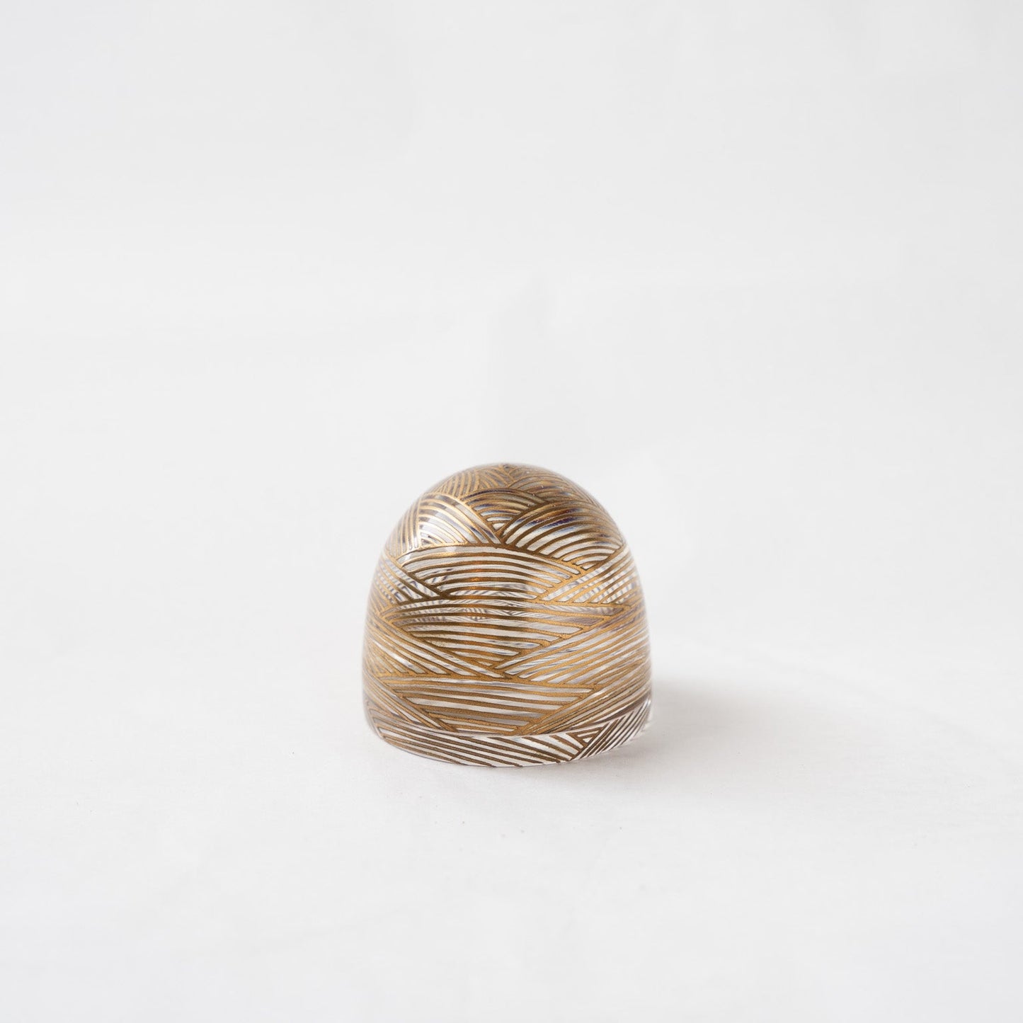 Front view of the #90 wave acrylic small box by Hariya, showing the closed dome-shaped container with fine gold lacquer wave patterns reflecting through the transparent body.