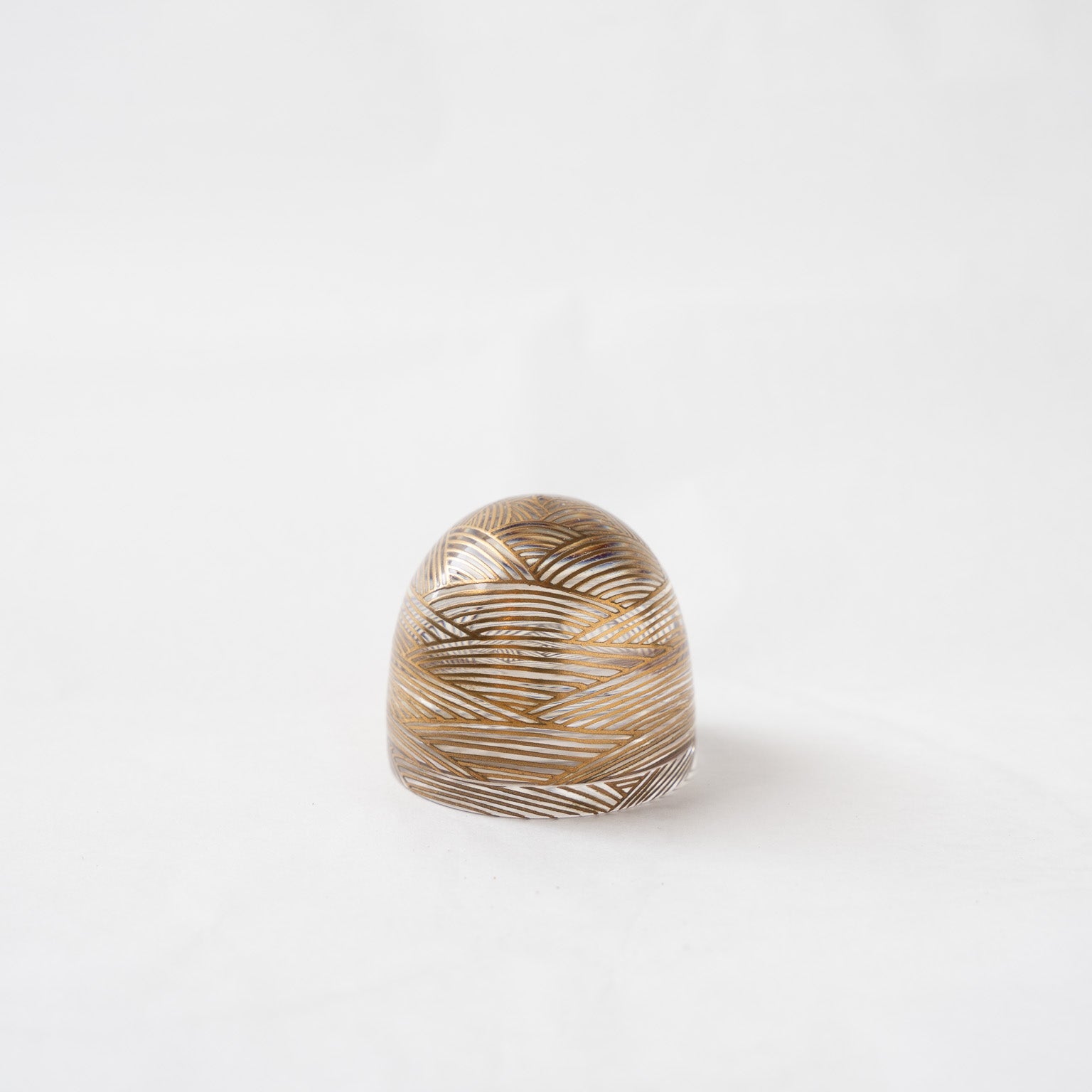 Front view of the #90 wave acrylic small box by Hariya, showing the closed dome-shaped container with fine gold lacquer wave patterns reflecting through the transparent body.
