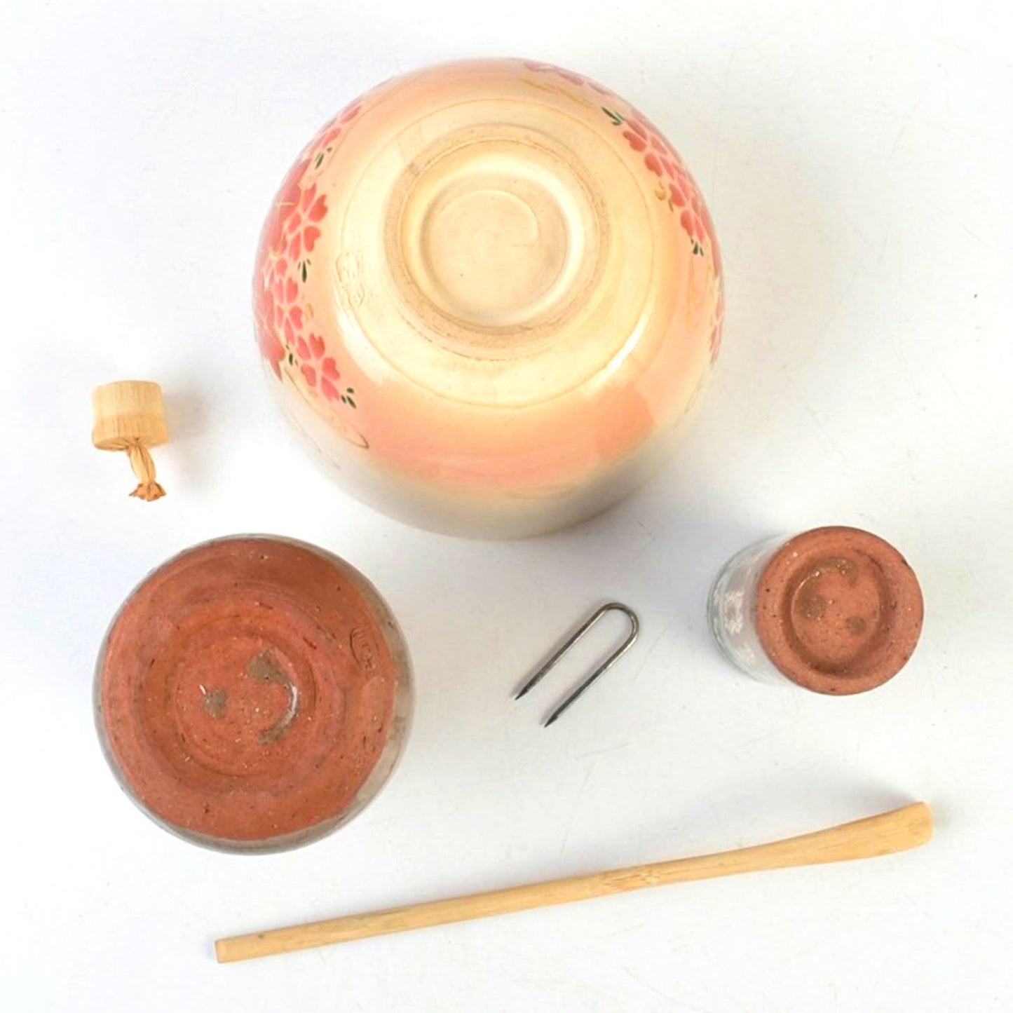 Base view of the CHAWAN showing the soft clay texture, accompanied by the unglazed, earthy feet of the FURIDASHI and CHAKIN-ZUTSU.