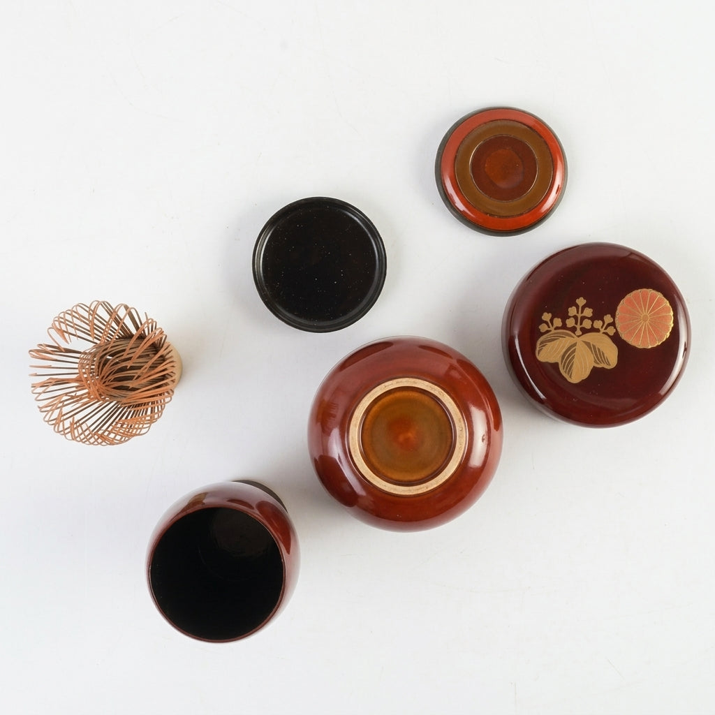Top and interior views of the lacquer tea caddy and containers, revealing the quiet depth of the material