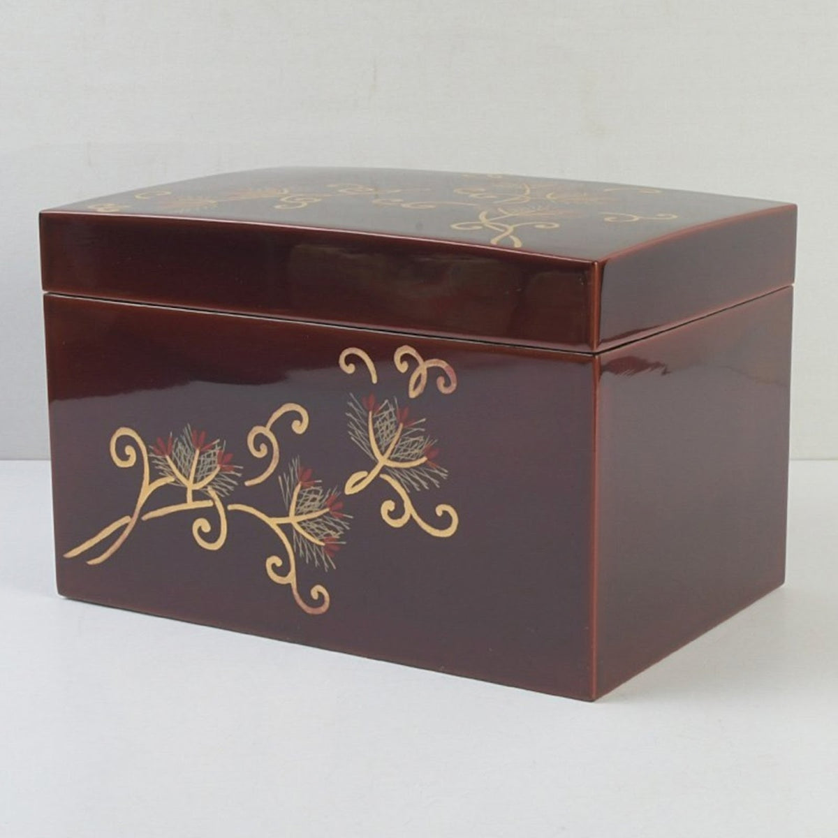 Front view of a wooden CHABAKO tea box with serene amber tame-nuri lacquer and delicate pine maki-e