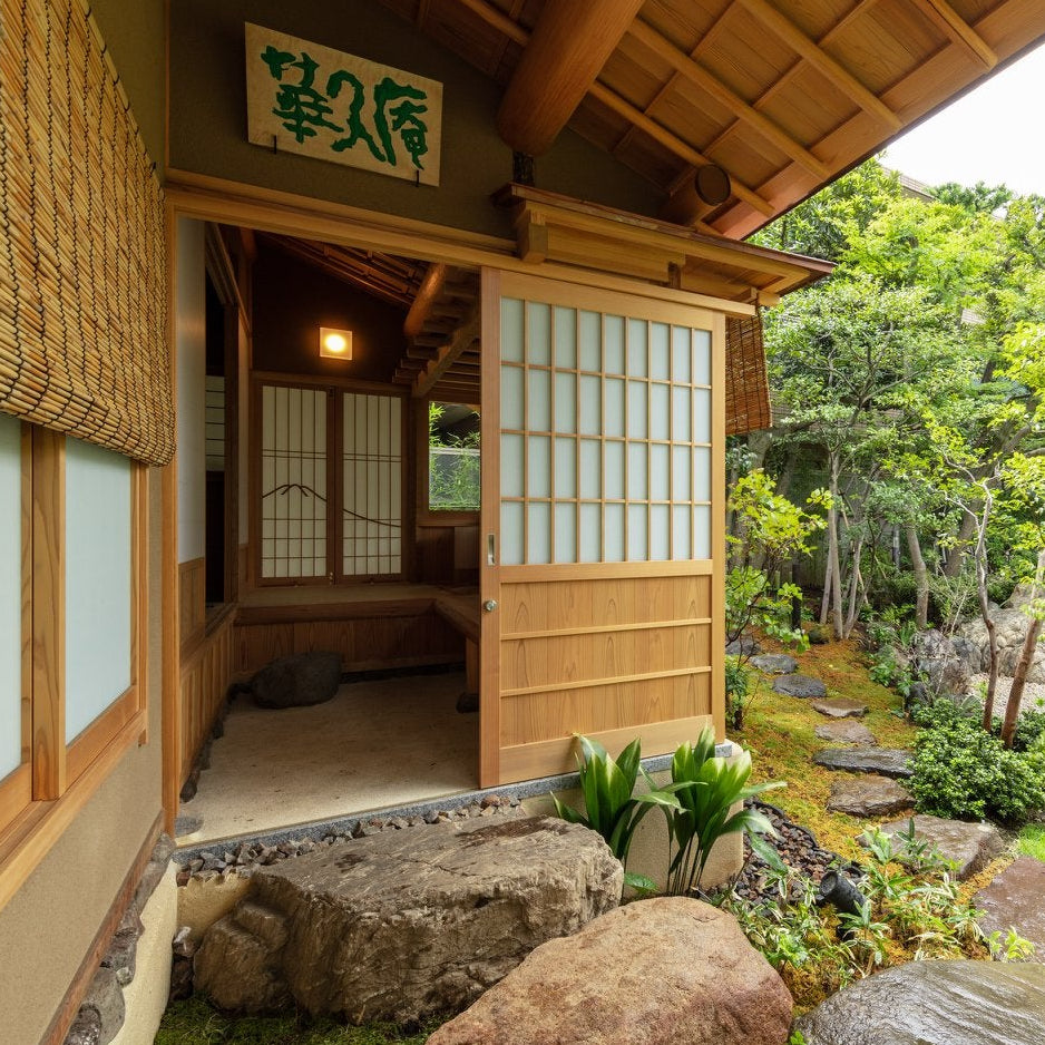 Tea house entrance opening onto a stone-and-moss garden, Japanese tea house architecture in Roppongi, Tokyo.