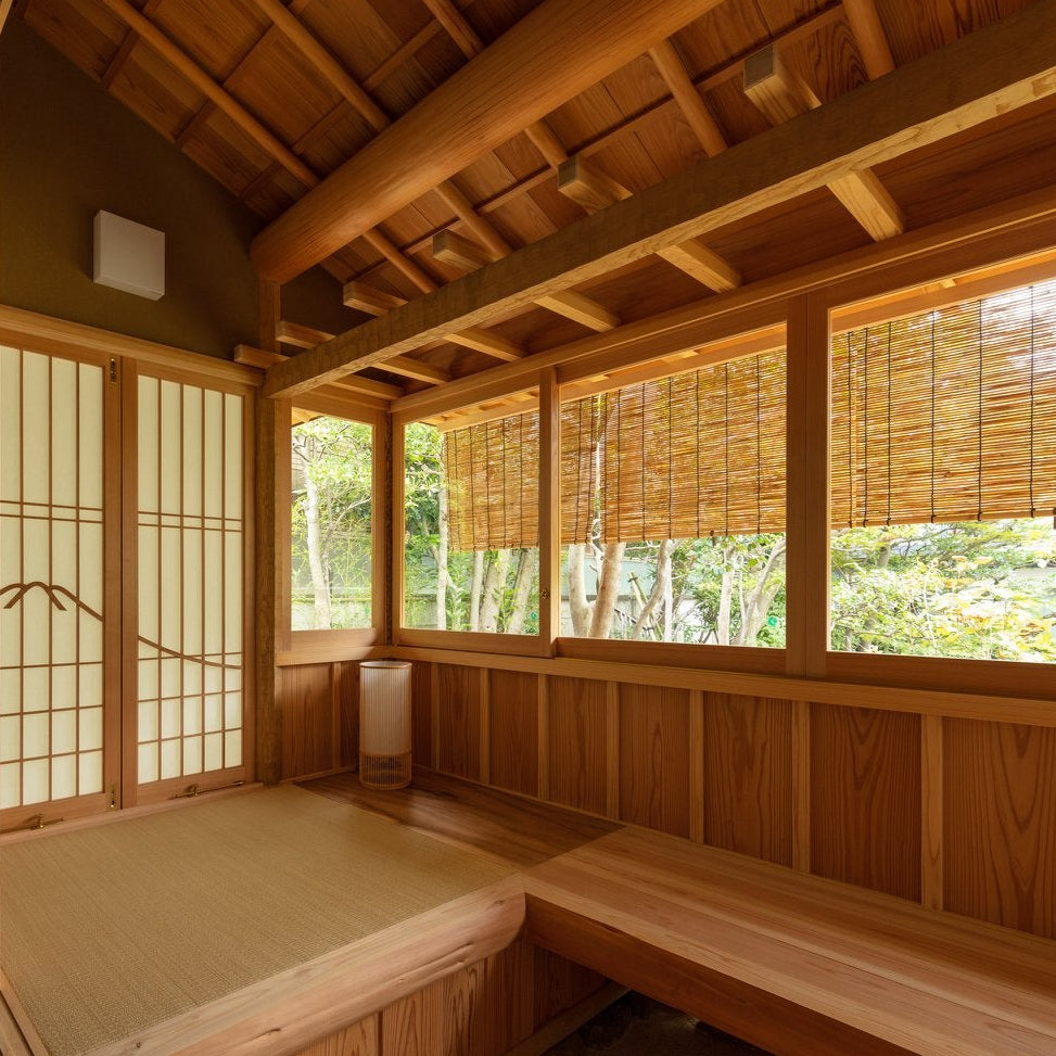 Engawa bench with bamboo sudare blinds and shoji framing a garden view, Japanese tea house architecture.