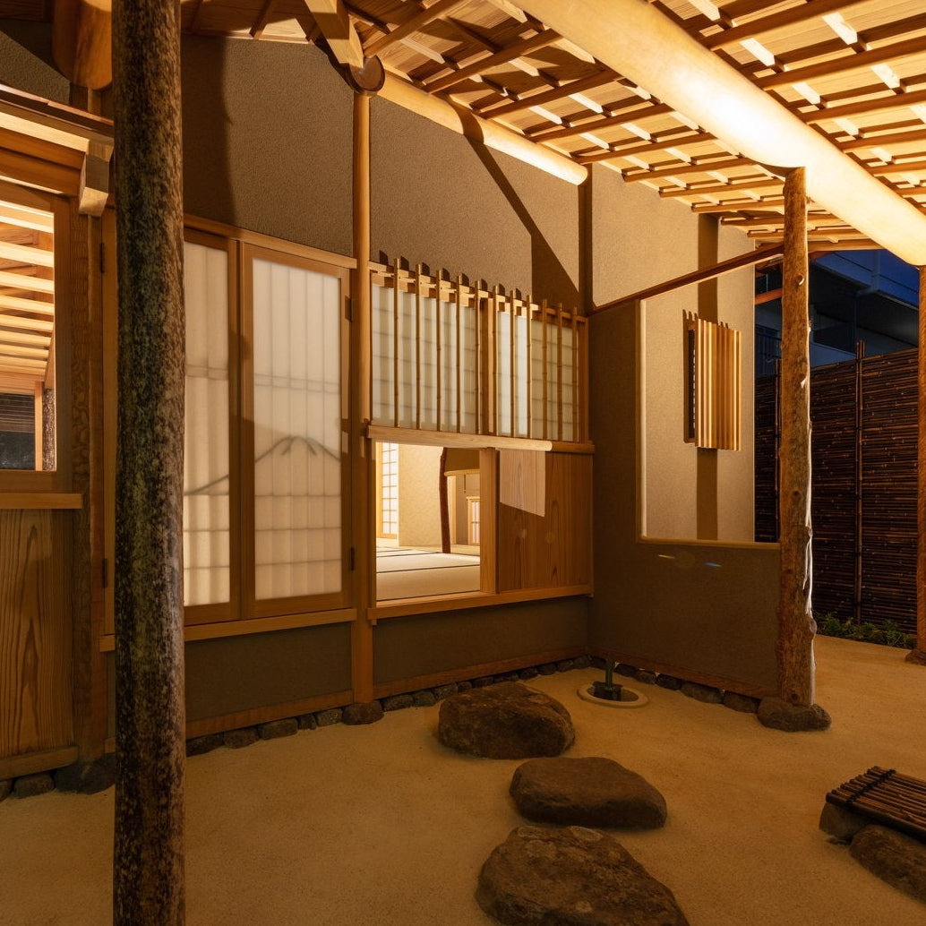 Veranda and stepping-stone garden of a chashitsu lit at night, showing Japanese tea room architecture.