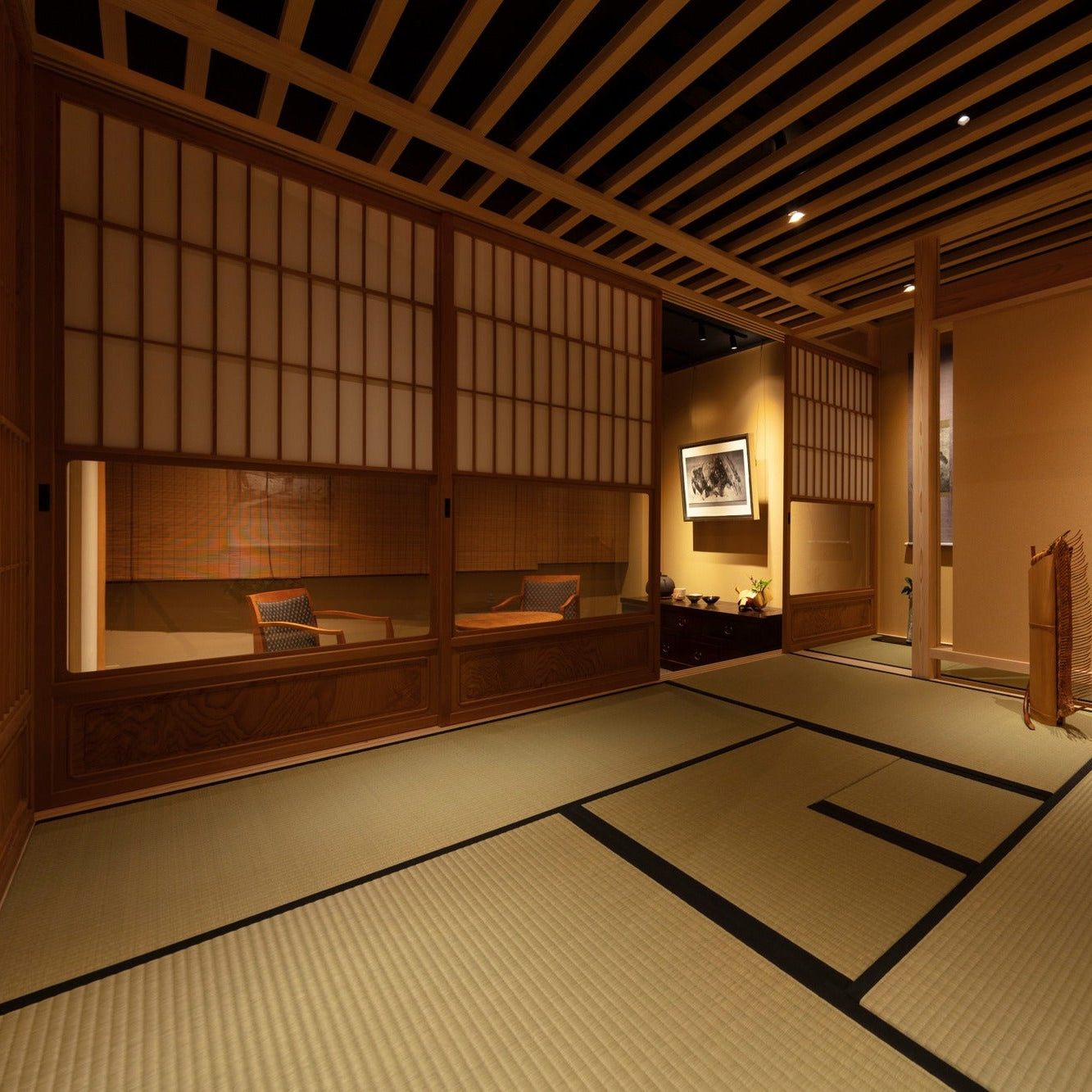 Wide view of a tatami tea room with a hanging scroll and a slatted ceiling beneath a Ginza gallery, refined Japanese interior.