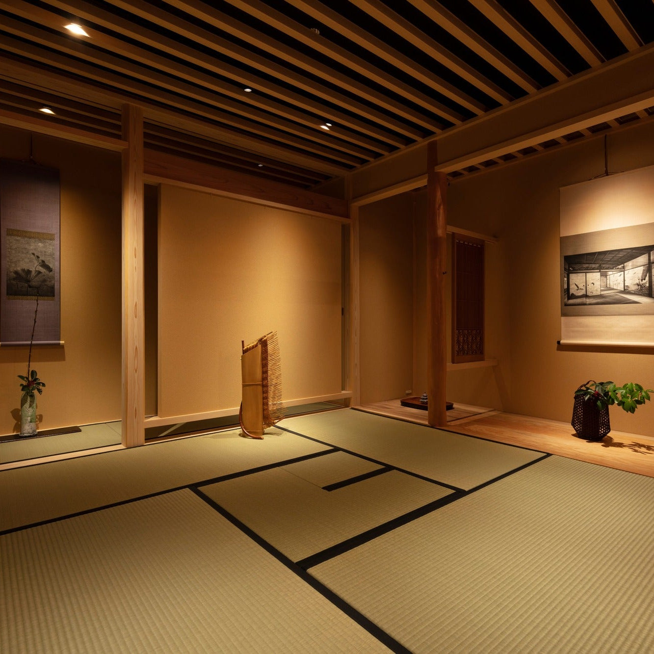 Tatami tea room with two hanging scrolls and a standing bamboo artwork, softly lit in a Ginza gallery.