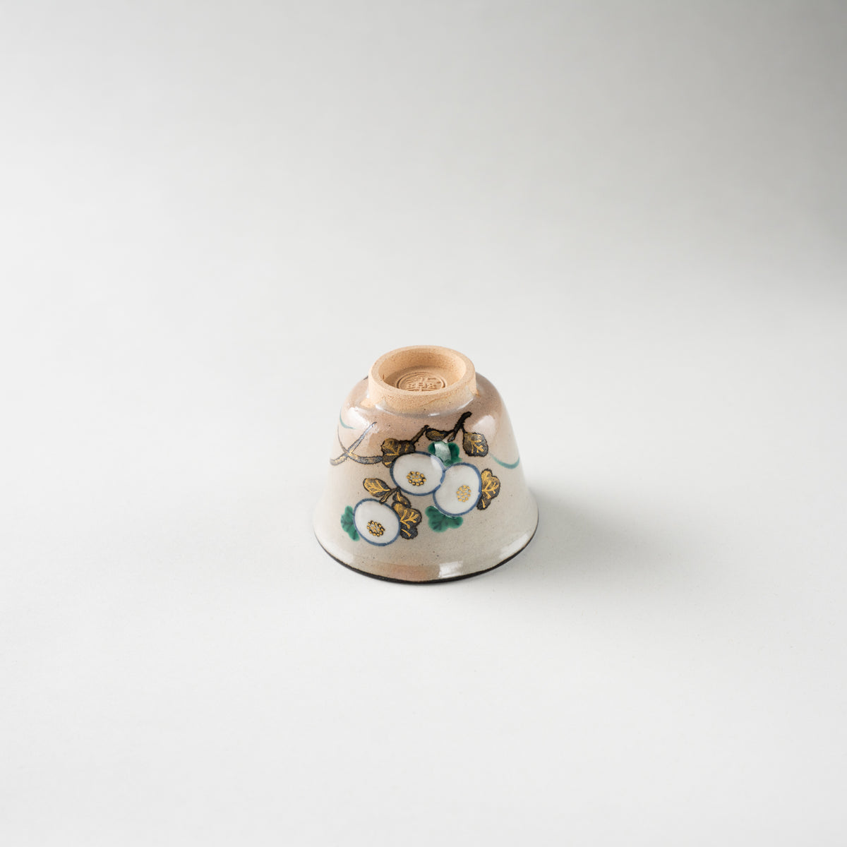 Inverted view of Eiraku Zengoro XVI's Kiku GUINOMI sake cup, revealing the unglazed clay foot and the impressed artist seal.