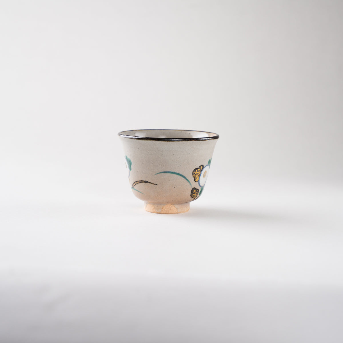 Studio view of the Kiku chrysanthemum GUINOMI sake cup by Eiraku Zengoro XVI, capturing the quiet elegance and soft luster of the Kyoto ceramic.