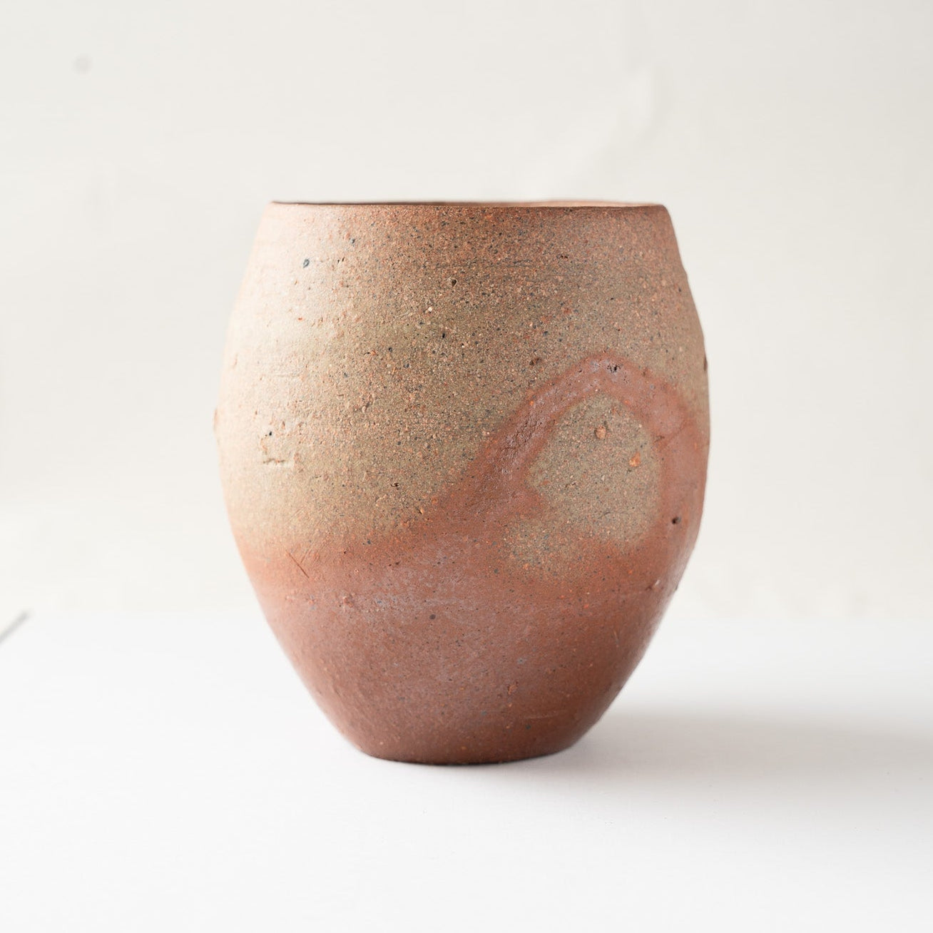 Profile shot highlighting the circular halo effect from the firing process, showcasing the natural ornamentation created by the kiln.
