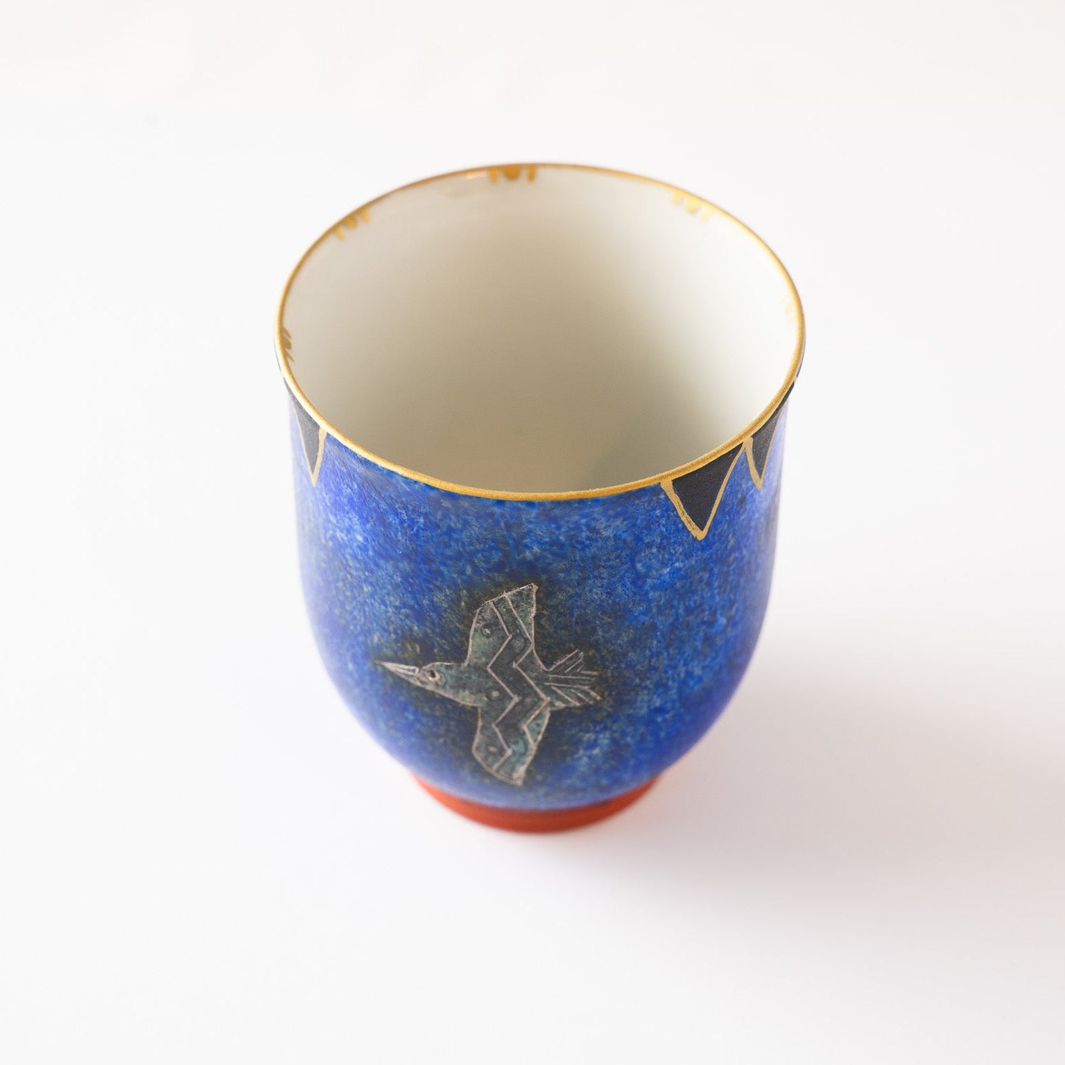 Alternative high-angle shot highlighting the complex textured blue glaze and the delicate engraving lines on the wings of the bird motif.