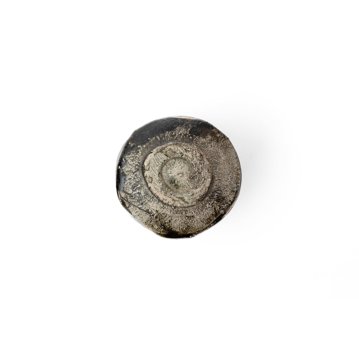 Underside of the bowl showing the unglazed grey-buff clay and the spiral-cut foot ring.