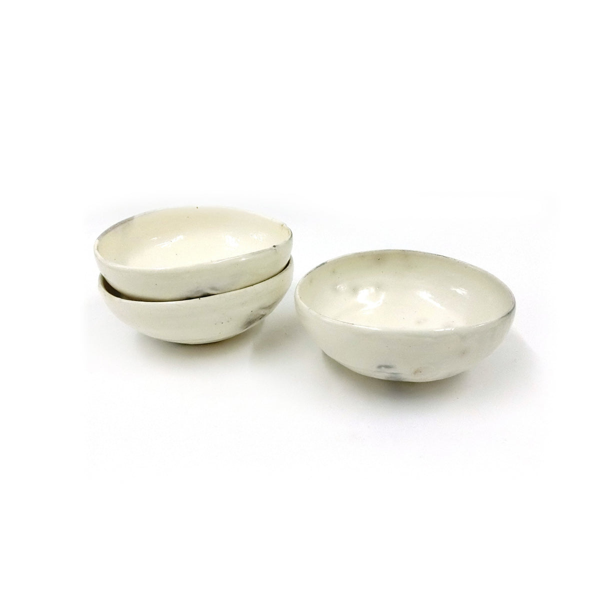 Three kohiki dishes shown together, two stacked and one apart, to show the consistency of the form; this listing is for one dish.