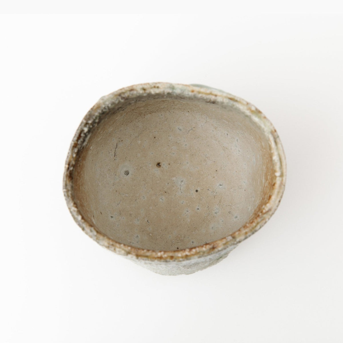 View down into the bowl, the interior smoother and lighter than the outside, with a pale well.