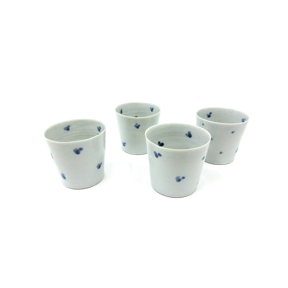 Four of the cups grouped together on a white ground showing the scattered flower pattern; sold individually.