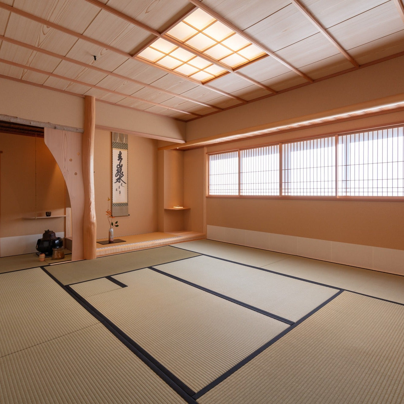 Full tea room inside the shop, the chashitsu set with a hanging scroll and a natural post