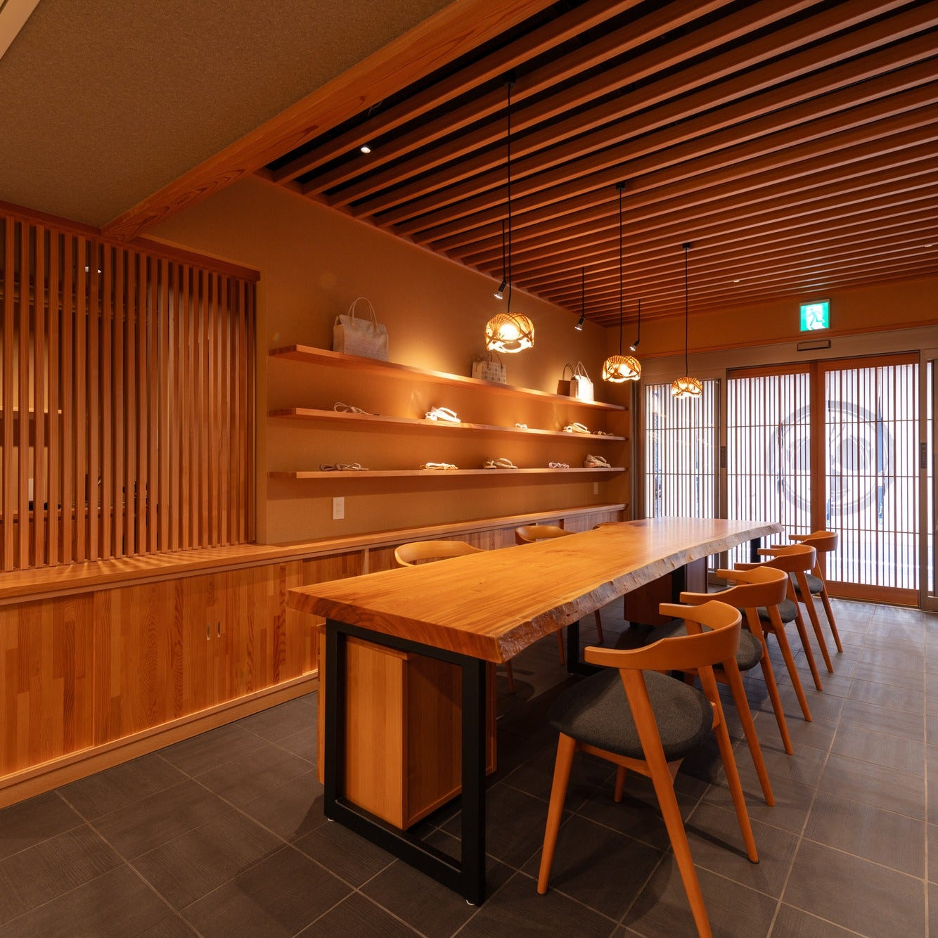 Reception counter beside a cedar lattice screen, with quiet Japanese architecture detailing