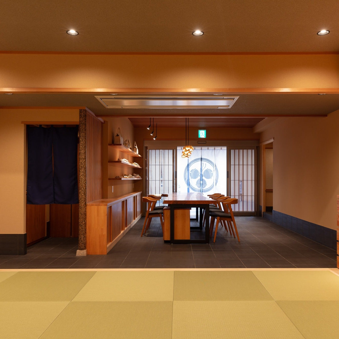 Entrance hall with a live-edge counter, display shelves and a tatami Japanese interior