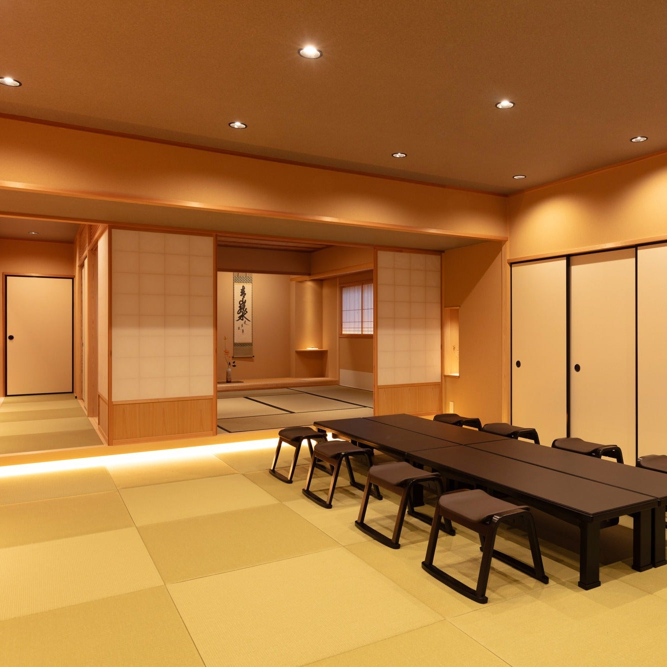 Tatami seminar space with low tables and stools, a flexible Japanese interior for events