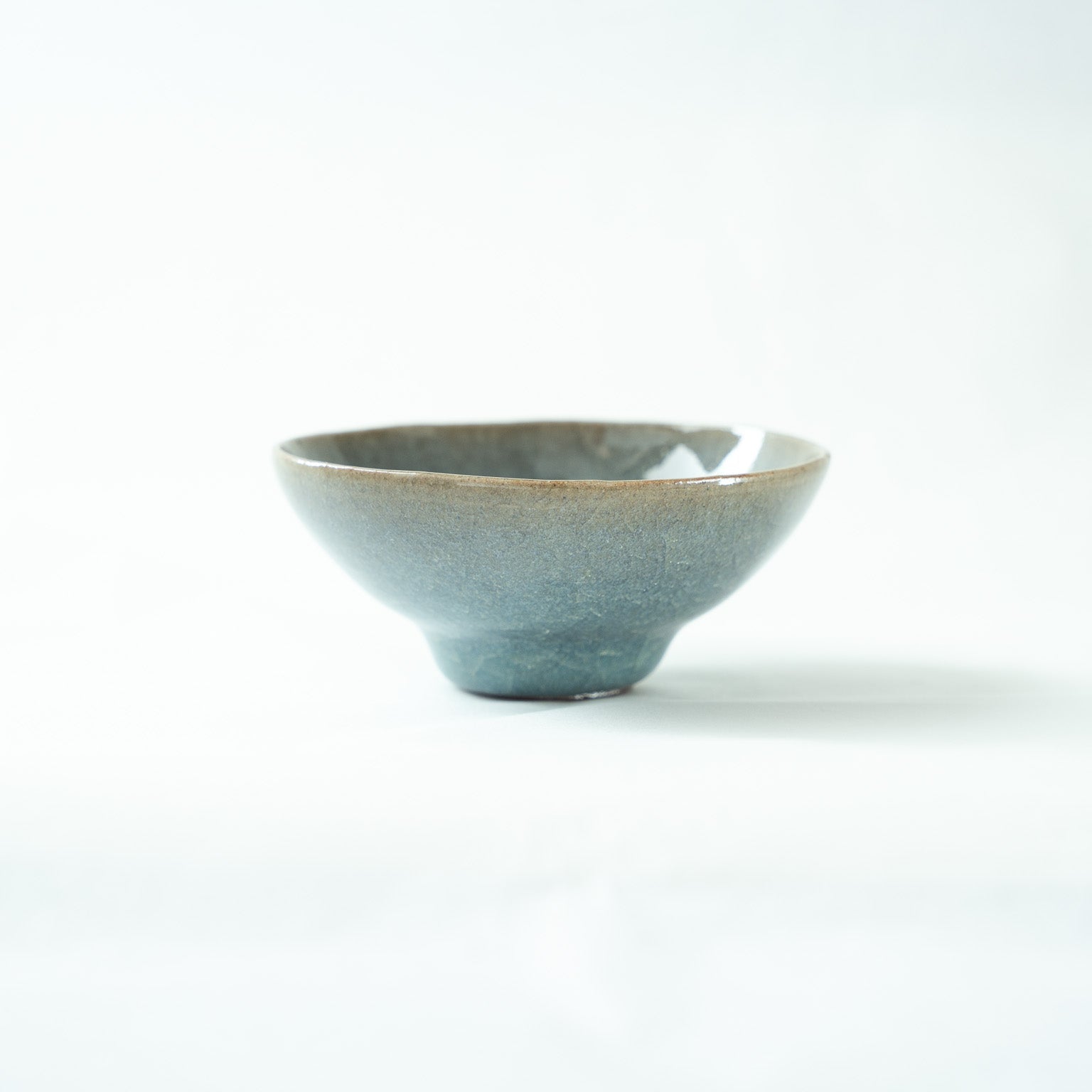 Another profile view of the vessel, showing the delicate crackle patterns running through the pale opaque blue glaze.