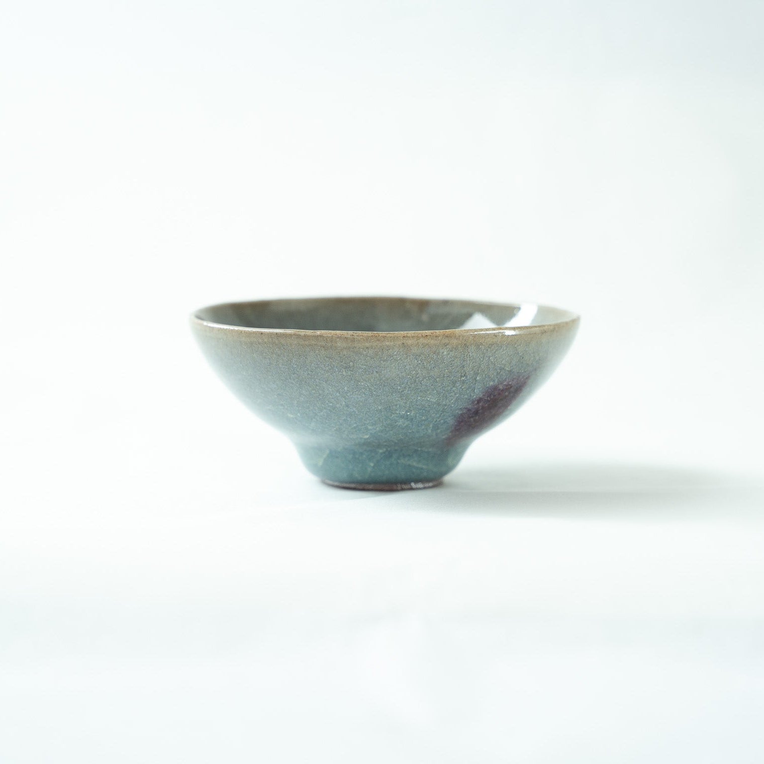 Profile view of the flared blue SAKAZUKI by Kiyoshi Hara, emphasizing the exquisite balance and gentle symmetry of its form.