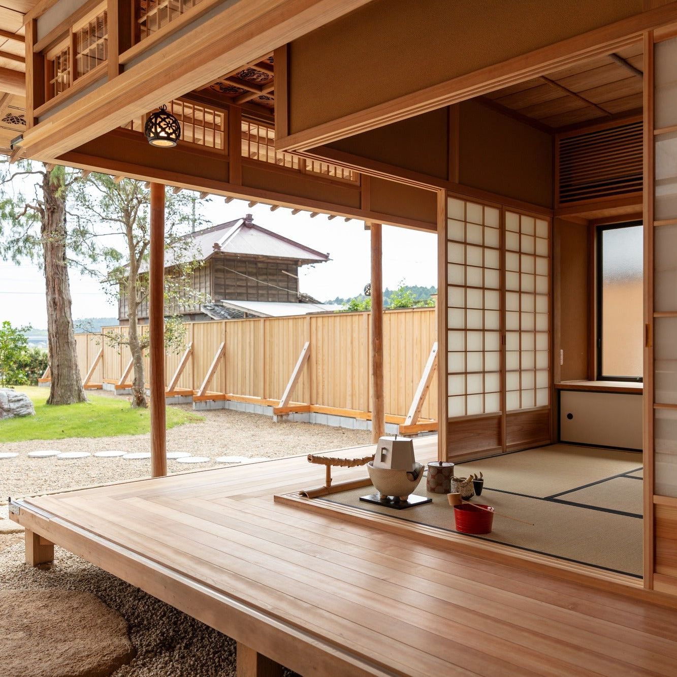 View from the chashitsu deck across the garden toward a distant earthen storehouse