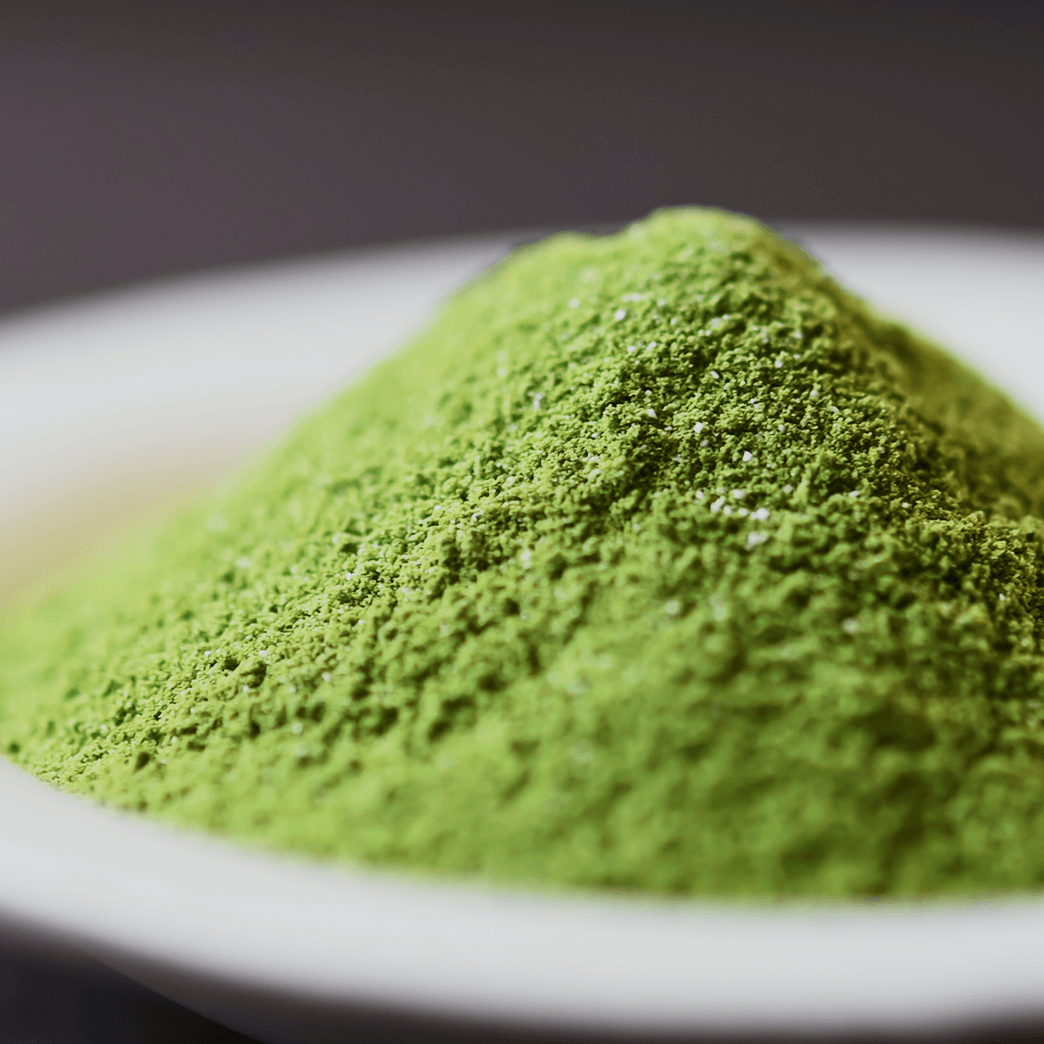 Matured Matcha "Shinonome no Shiro" — bright green usucha powder mounded in a white dish against a dark background.