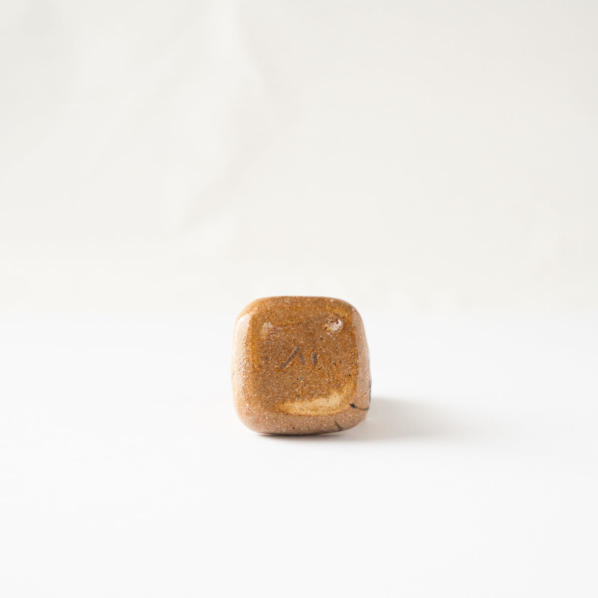 Bottom view of the Oribe miniature KOGO ceramic box, revealing the flat unglazed base and potter's mark.
