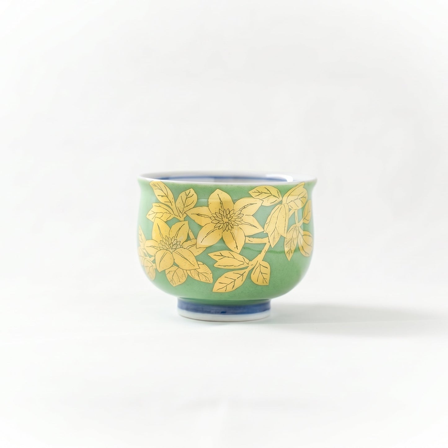Front view of the Kutani GUINOMI by Mitsuru Yoshida, featuring delicate underglaze gold leaf floral motifs on a vibrant green glaze.