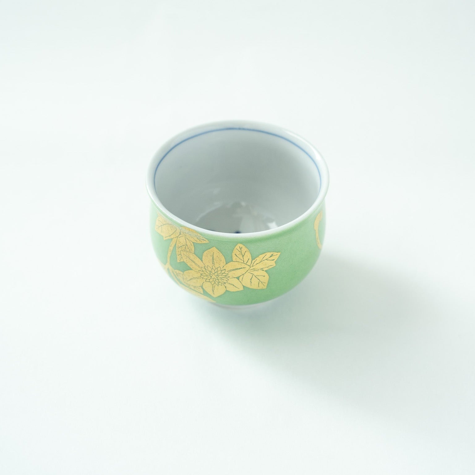 Top view showing the pure white inside of the bowl with a glimpse of the blue underglaze floral pattern at the very bottom.