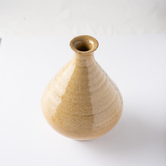 High-angle perspective focusing on the flared rim and slender neck of Noriyuki Furutani’s yellow glaze TOKKURI.