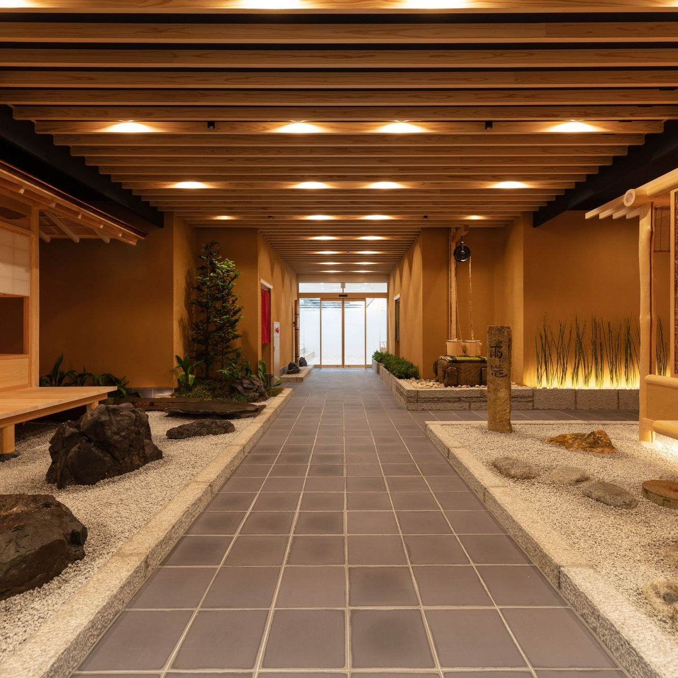 A stone-paved corridor runs between dry gravel gardens and benches, a street of Japanese architecture on a single floor.