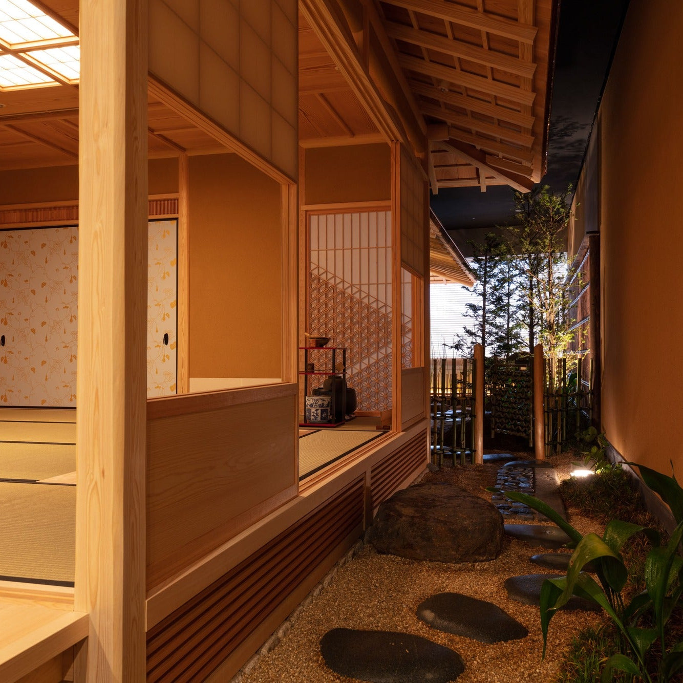 An engawa runs past a courtyard garden, with ginkgo-patterned sliding doors framing the rooms, layered Japanese architecture.