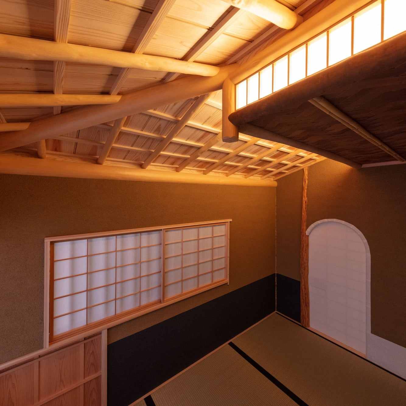 Looking up to a sloped bamboo-and-timber ceiling and an arched opening, the craft of Japanese architecture overhead.