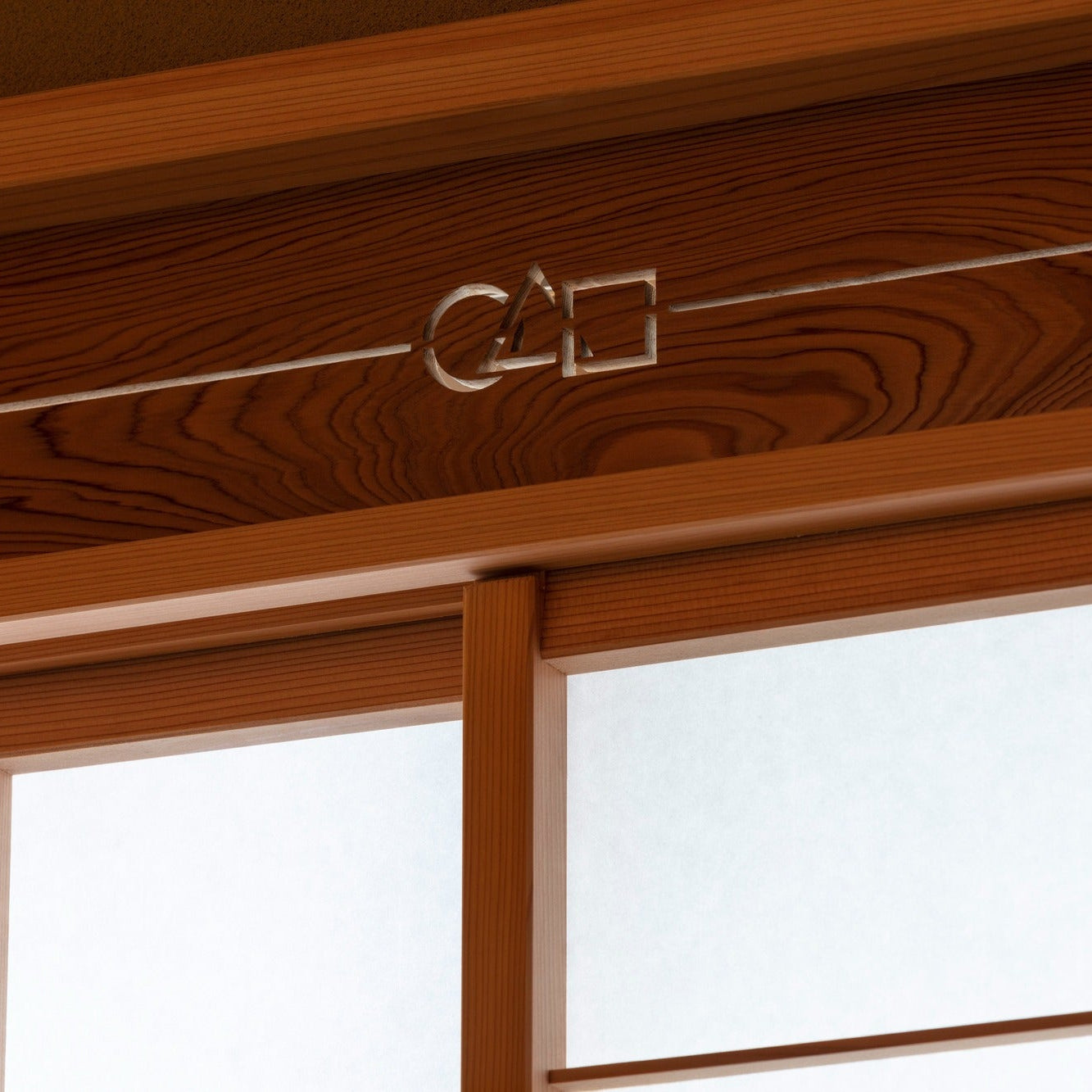 Openwork transom carved with a circle, triangle and square in cedar grain, a fine detail of Japanese architecture.