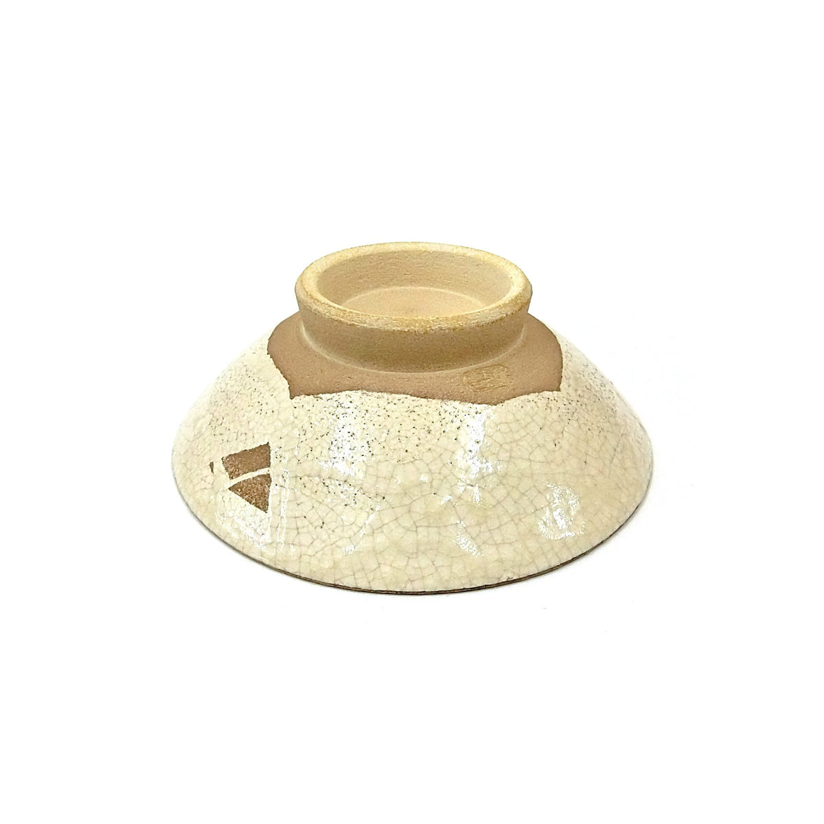 A bowl turned over to show the bare foot ring and the crackled glaze on the underside.