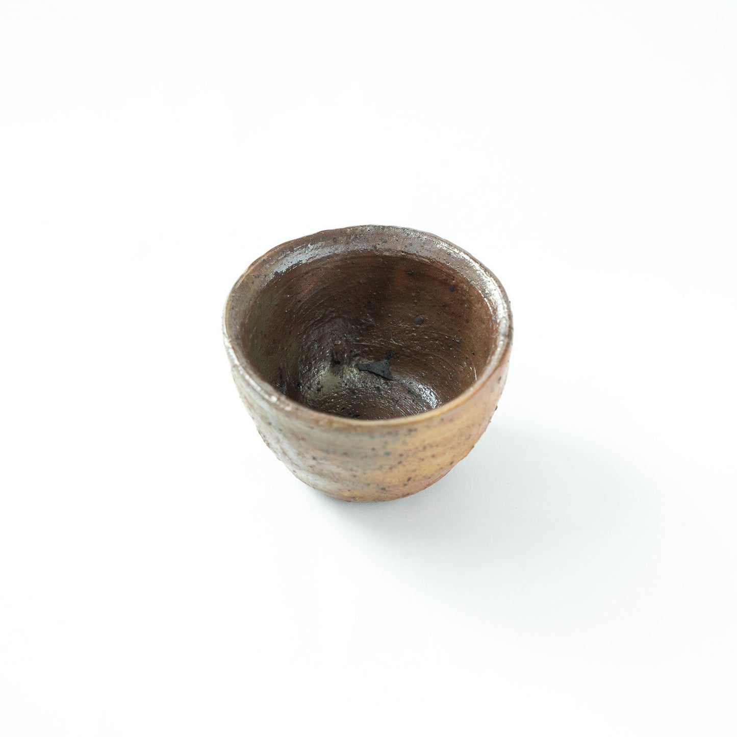Interior view of the rustic bowl by Shiro Tsujimura, emphasizing the energetic wheel marks and primal depth of the vessel.