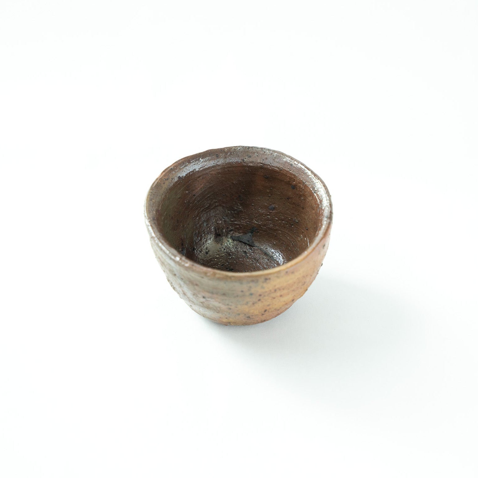 Interior view of the rustic bowl by Shiro Tsujimura, emphasizing the energetic wheel marks and primal depth of the vessel.