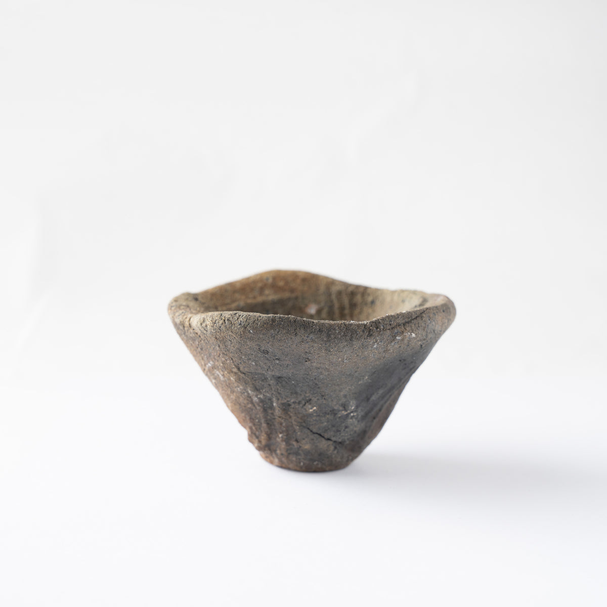 Low-angle view of the flared GUINOMI sake cup by Tamotsu Funakoshi against a clean studio backdrop.
