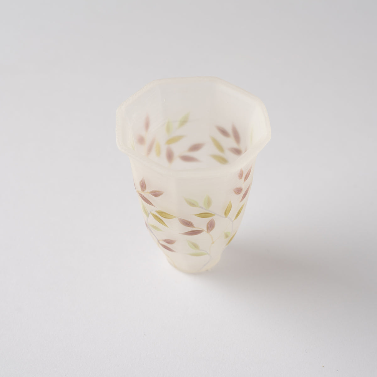 Top-down perspective of Toru Sato’s octagonal glass GUINOMI, displaying the open faceted rim and delicate leaf motifs inside.