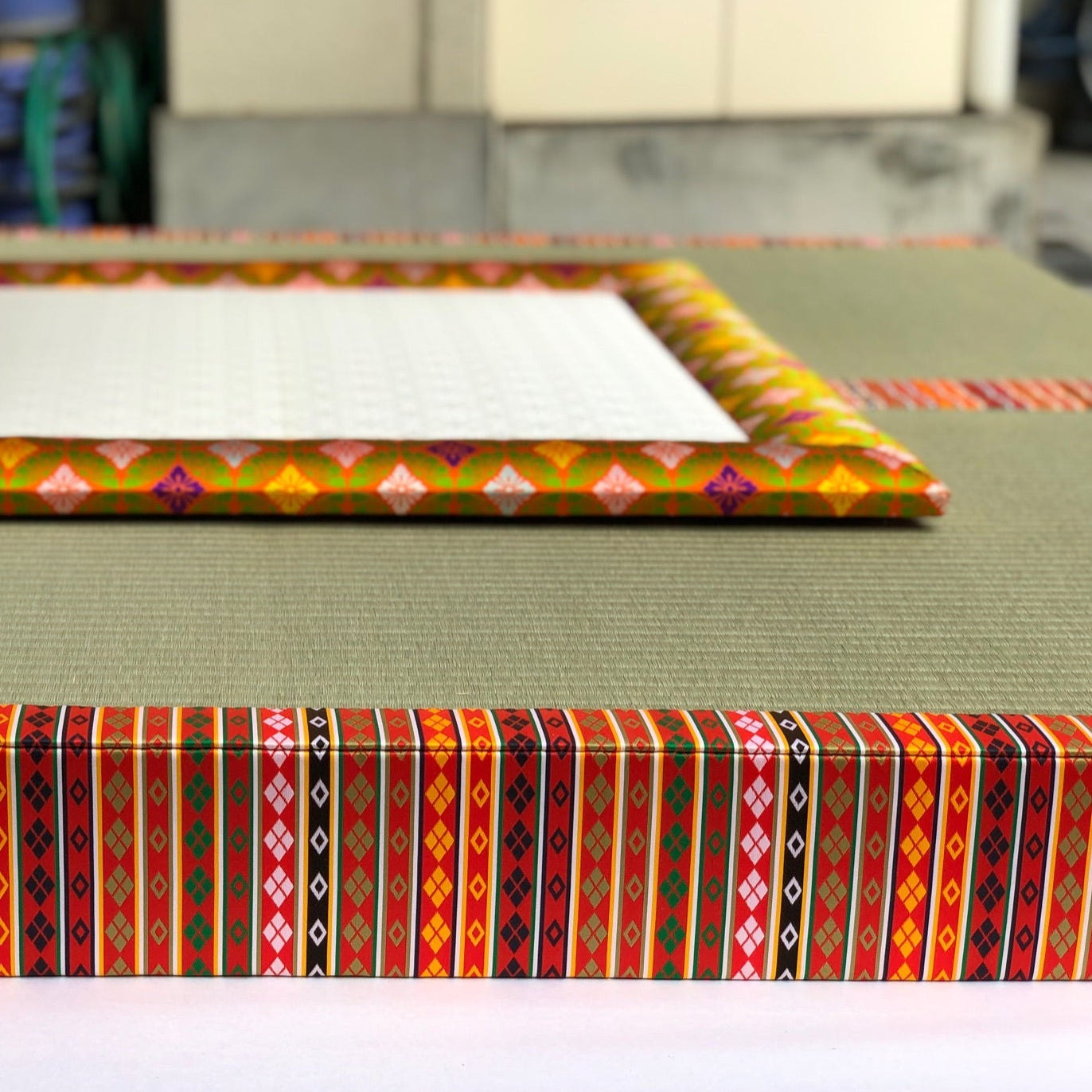 A traditional Japanese Yusoku tatami mat with an intricate patterned brocade border.