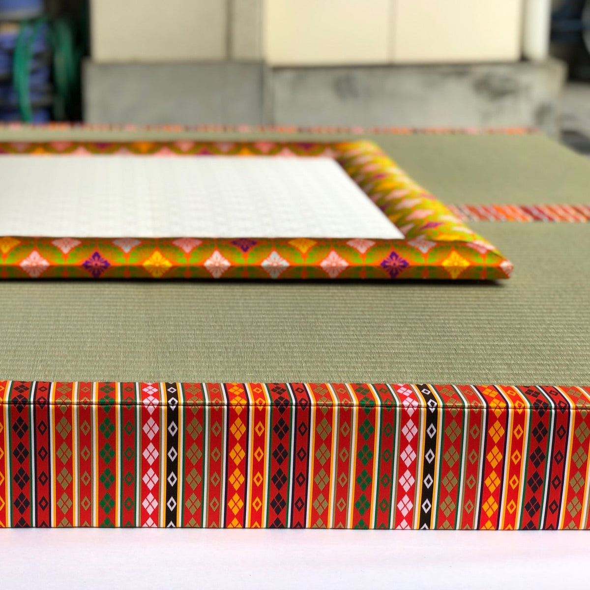A traditional Japanese Yusoku tatami mat with an intricate patterned brocade border.