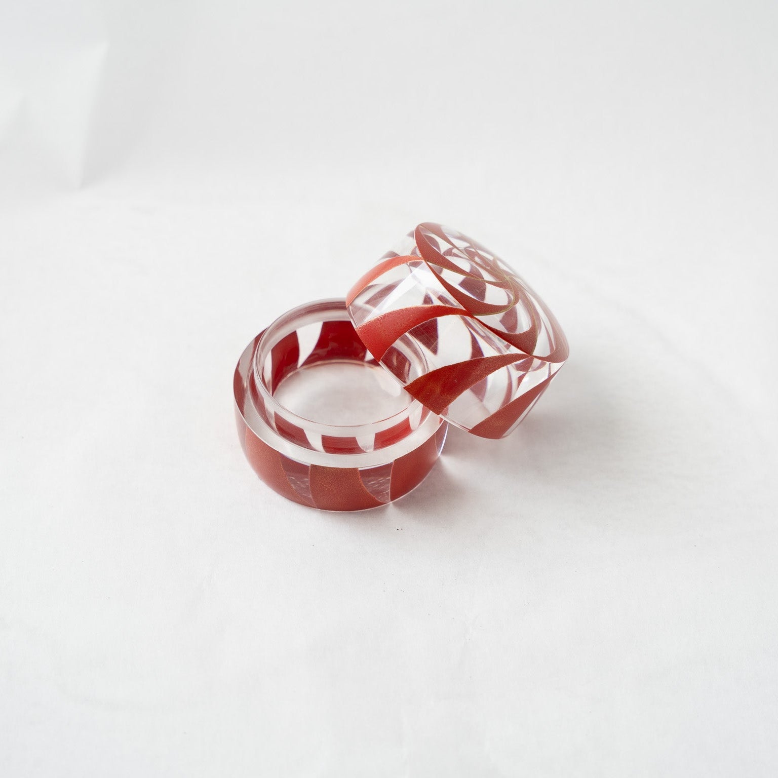 Looking down into the opened acrylic Makie container, illustrating the layered visual depth and geometric reflections caused by the translucent material.