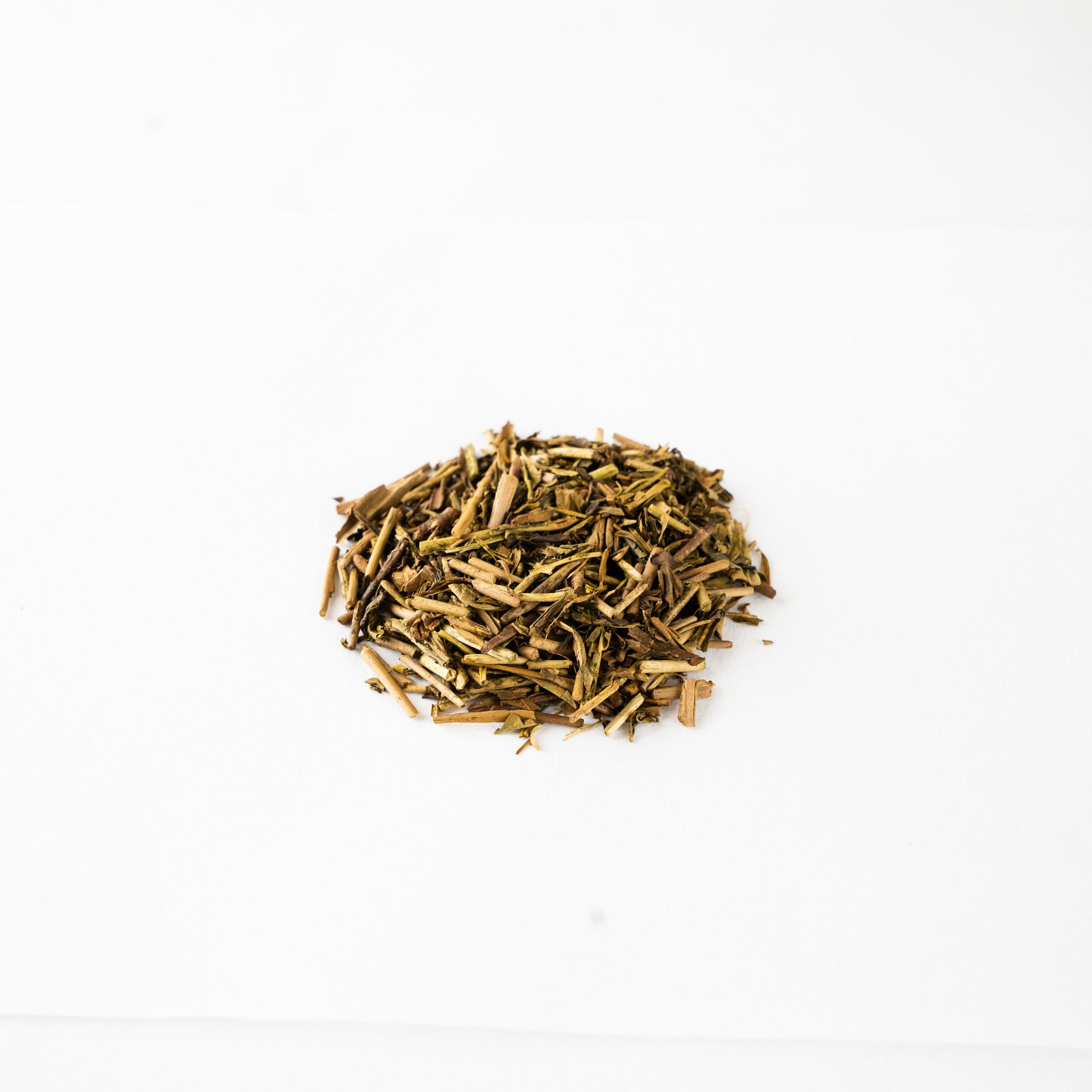 Top view of premium roasted hojicha leaves, highlighting the subtle color variations of the first flush harvest.