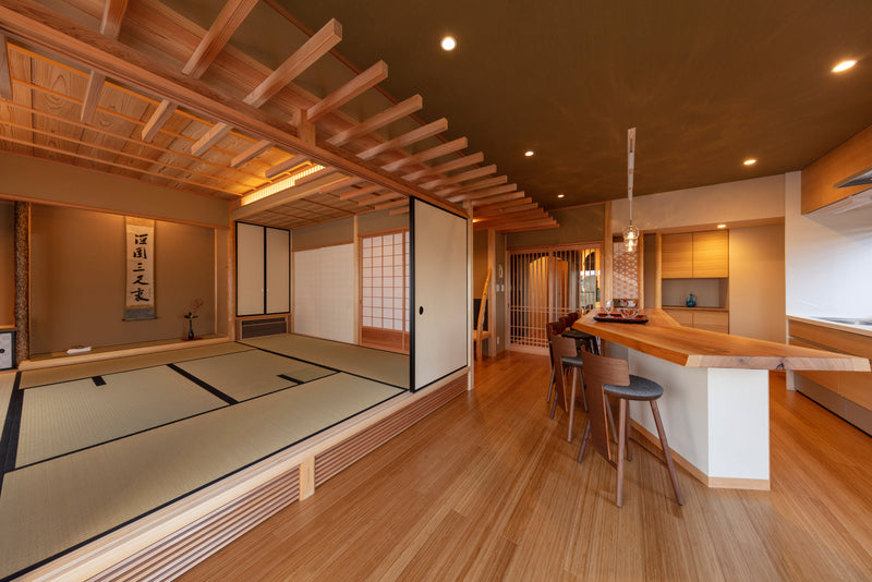 Architectural depth defined by warm wood grain and soft light, where traditional timber joinery and sliding shoji screens gently transition into a modern dining space.