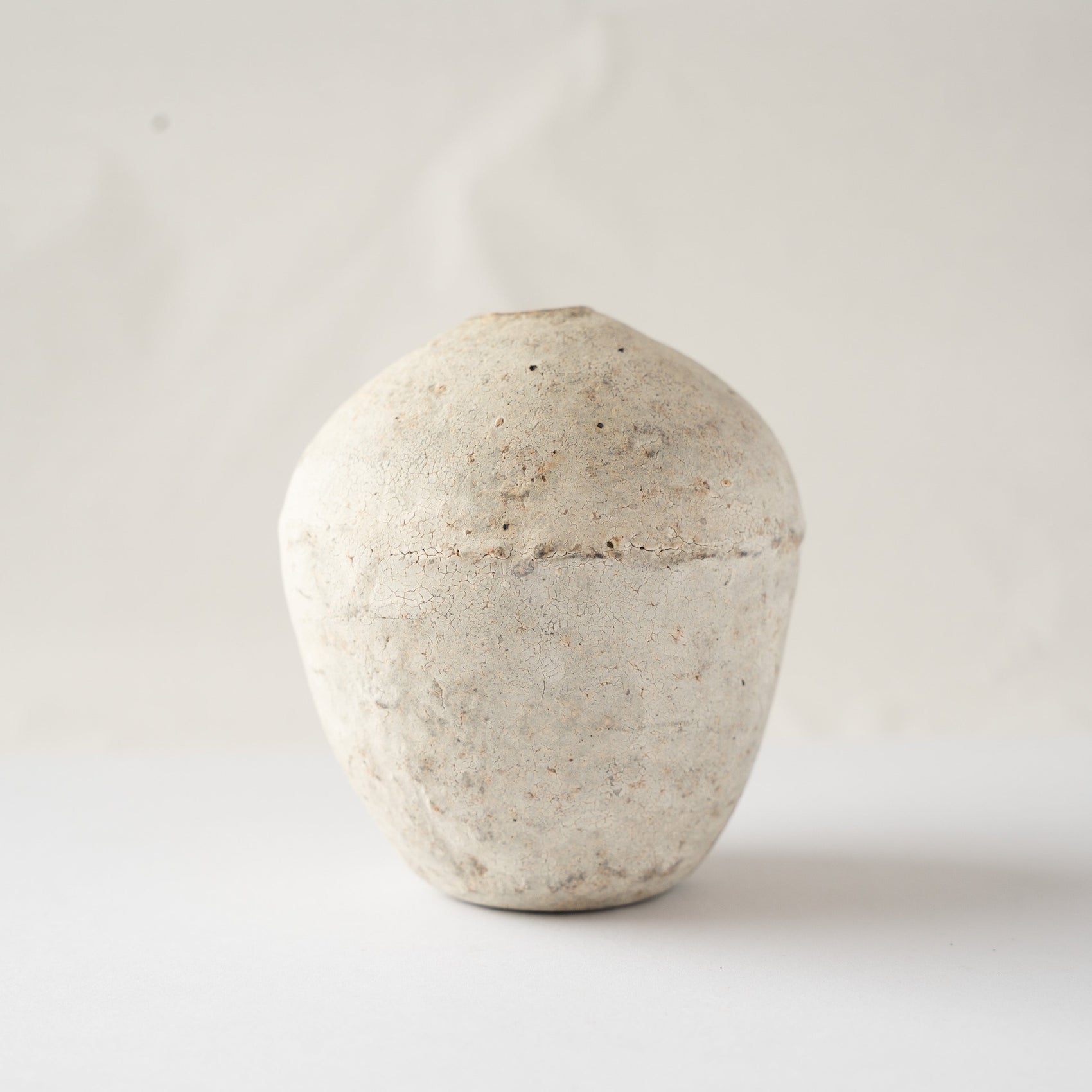 Front profile of Wataru Myosyu's Hakkoku Ko ceramic HANAIRE vase, displaying a swelling urn silhouette and chalky bone-white crackle surface.
