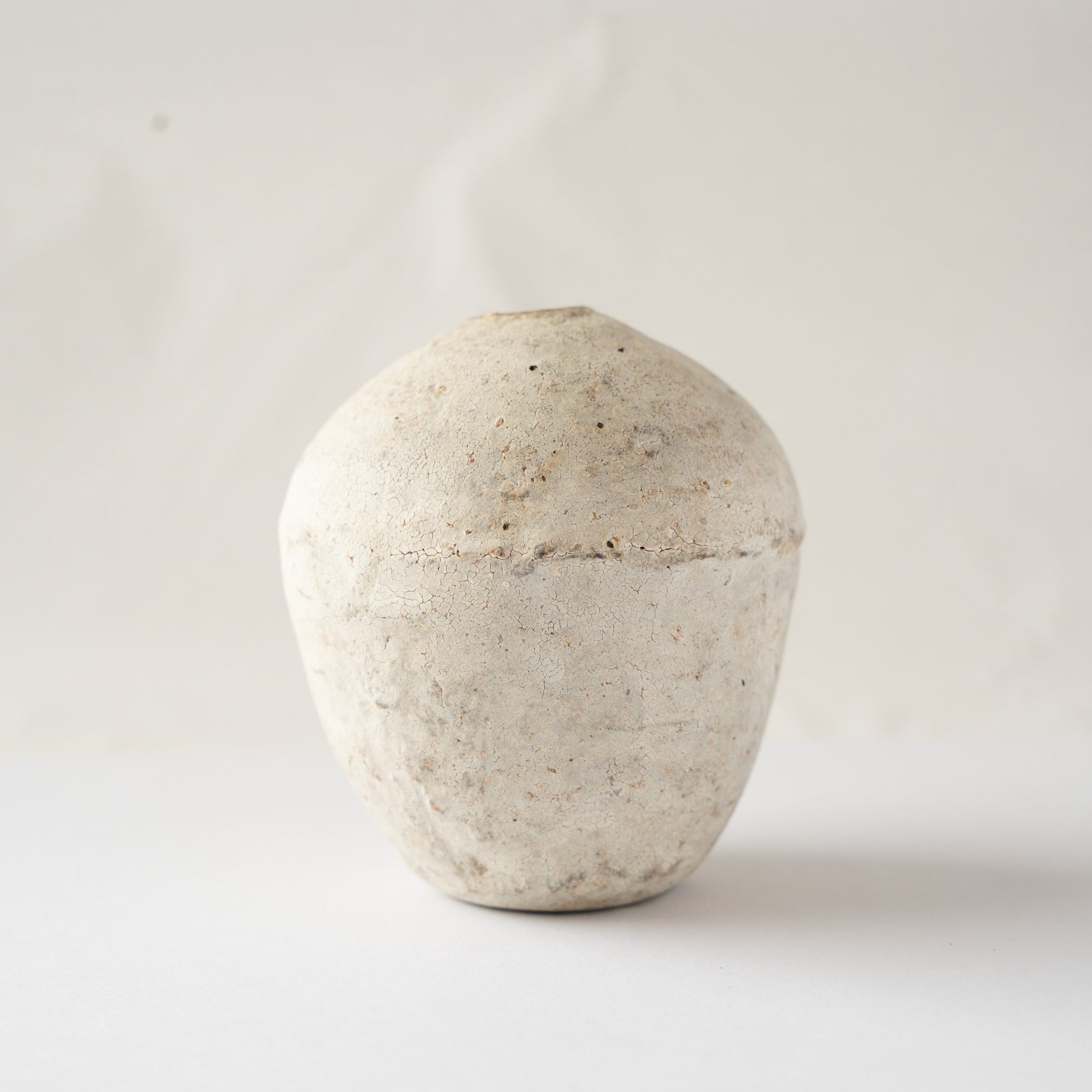 Front profile of Wataru Myosyu's Hakkoku Ko ceramic HANAIRE vase, displaying a swelling urn silhouette and chalky bone-white crackle surface.