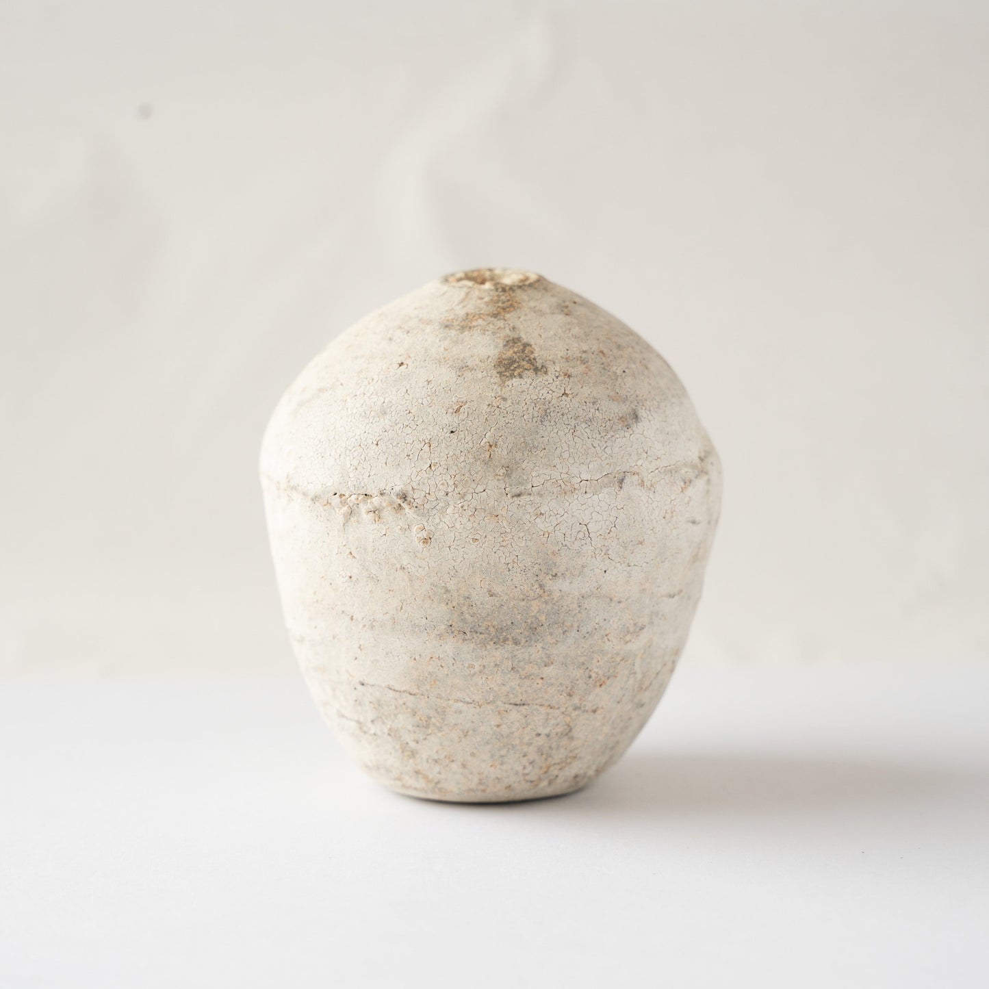 Alternate turned view of the Hakkoku Ko HANAIRE flower vase by Wataru Myosyu, detailing the weathered mineral-like ceramic texture.